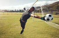 a goalkeeper saving a shot - Futbolinfo.az